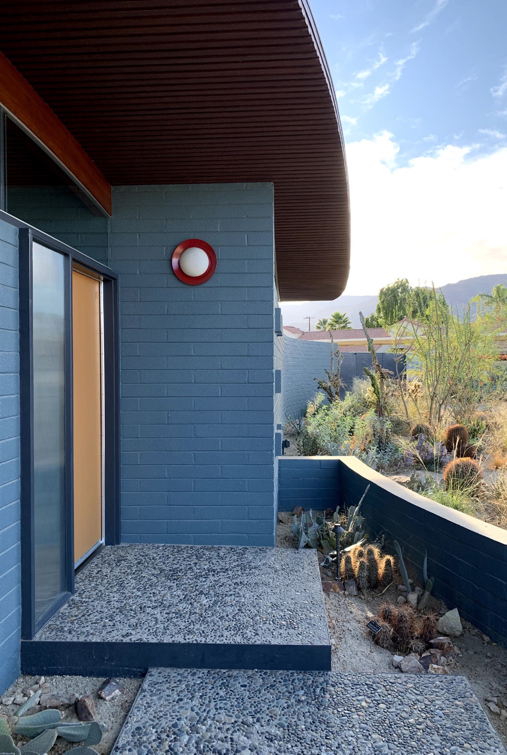 Rehabilitated front entry, removed addition, new entry wall and aggregate steps, 